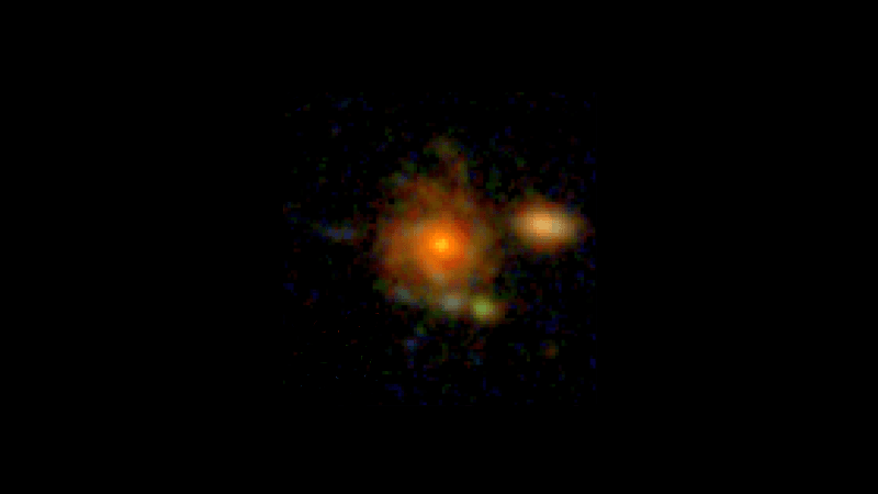 A pixelated face-on spiral galaxy sit a the center of the image. next to it a small elliptical is visible.